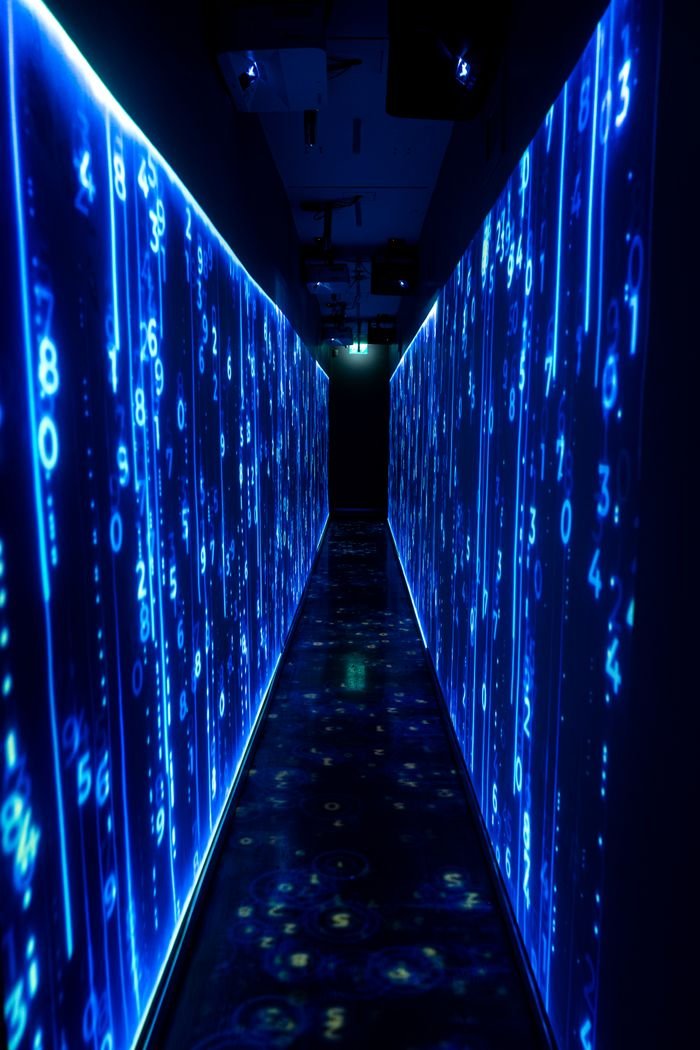 Hello world! A luminous blue tunnel with digital numbers creating a futuristic, sci-fi ambiance.
