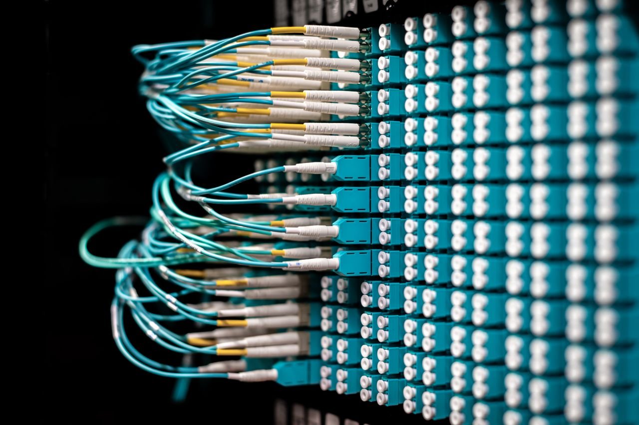 our-story Server with electronic switches and connectors with yellow and green wires plugged in plastic device in operating room on black background